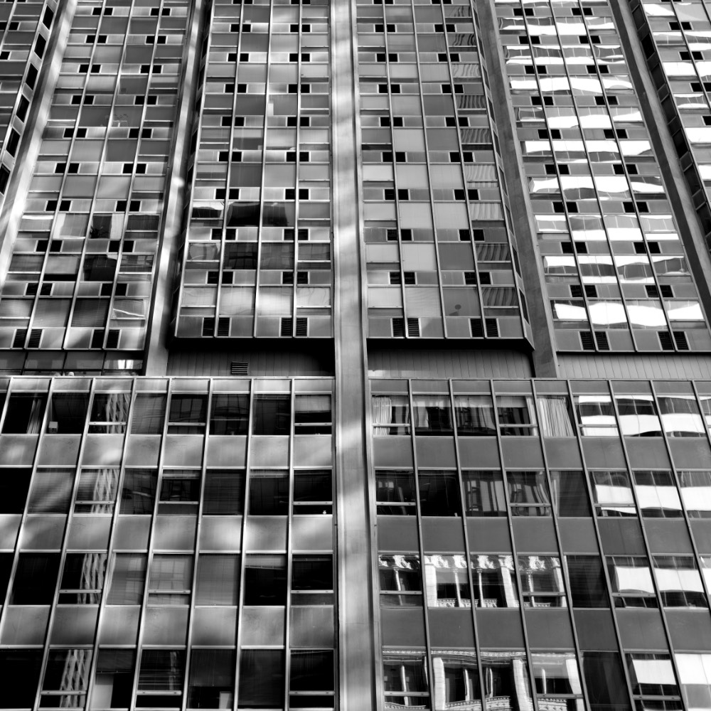 B&W photo of a close up of an office building looking up